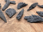 Raw black kyanite fan gemstone from GemstoneGO, showcasing natural, rough stone with fan-shaped formation and deep black color.