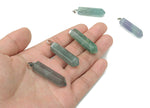 Purple fluorite point crystal pendant from GemstoneGO, ideal for jewelry making, showing a polished mineral with natural banding.