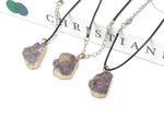 Amethyst cluster crystal necklace with cord, showcasing a vibrant purple gemstone pendant on a black cord.