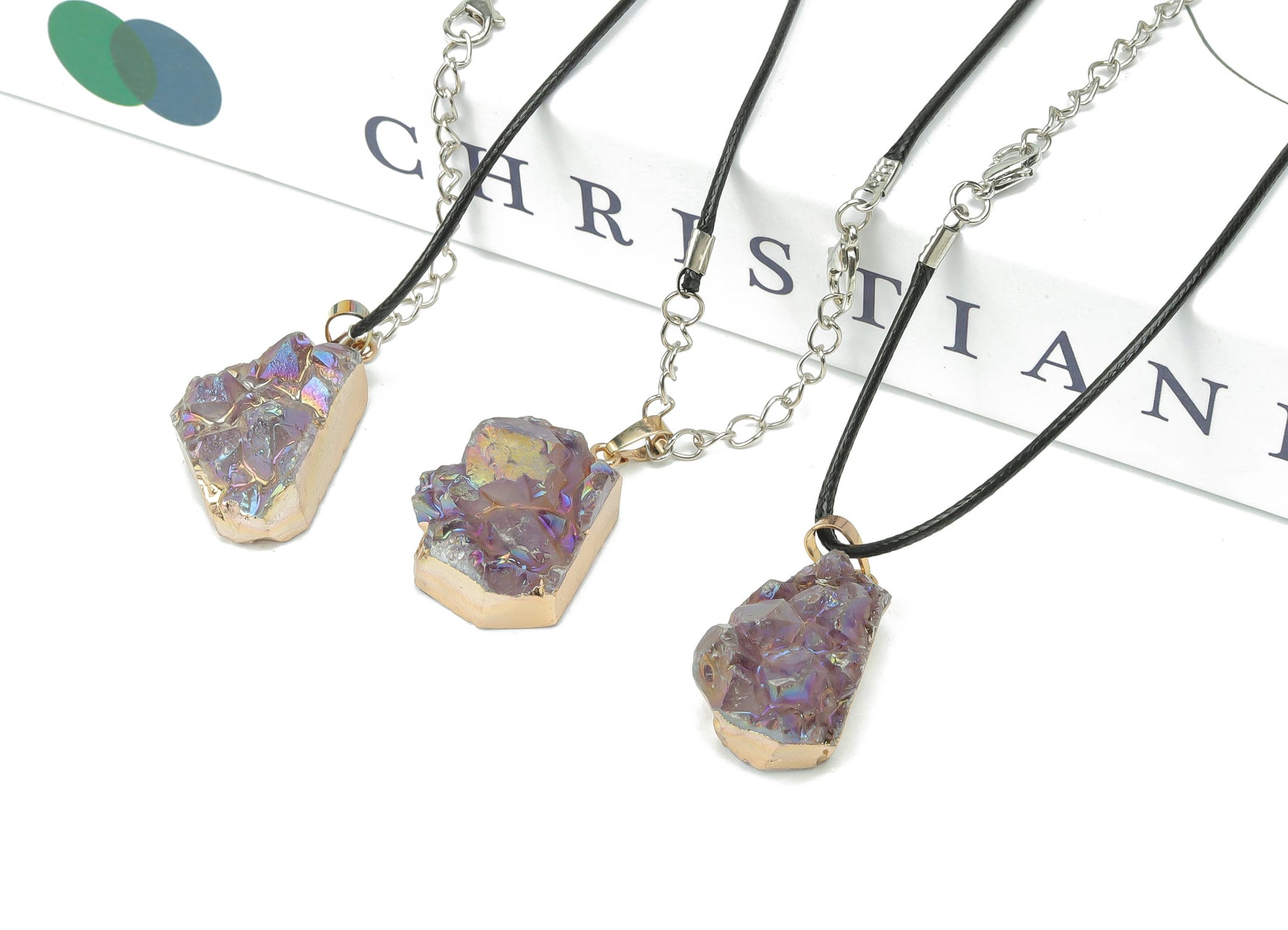 Amethyst cluster crystal necklace with cord, showcasing a vibrant purple gemstone pendant on a black cord.