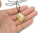 Yellow aura quartz crystal necklace on cord from GemstoneGO, showcasing a vibrant, polished gemstone pendant.