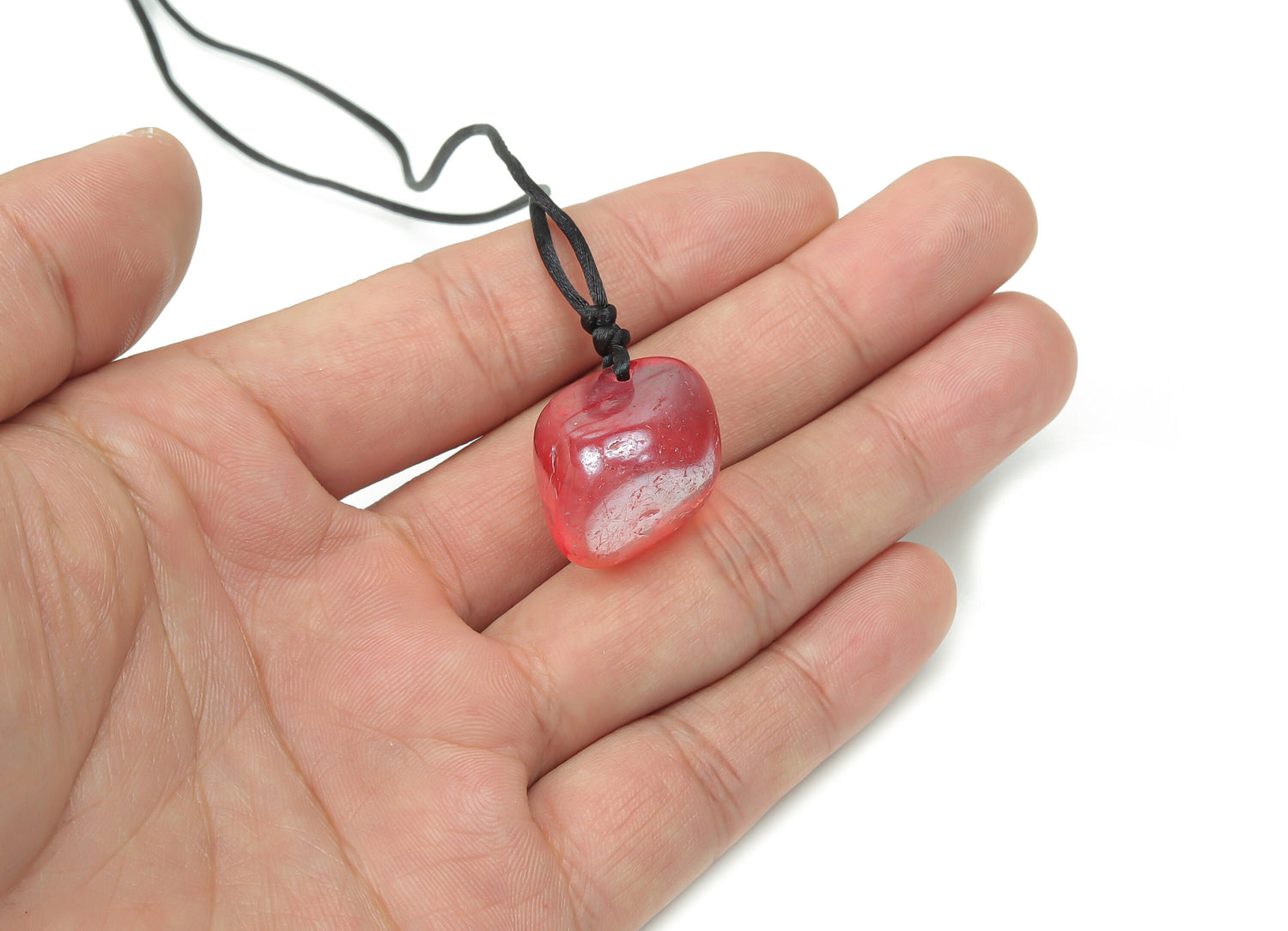 Red Aura Quartz crystal necklace on a cord, showcasing vibrant red gemstone with a natural, polished finish.