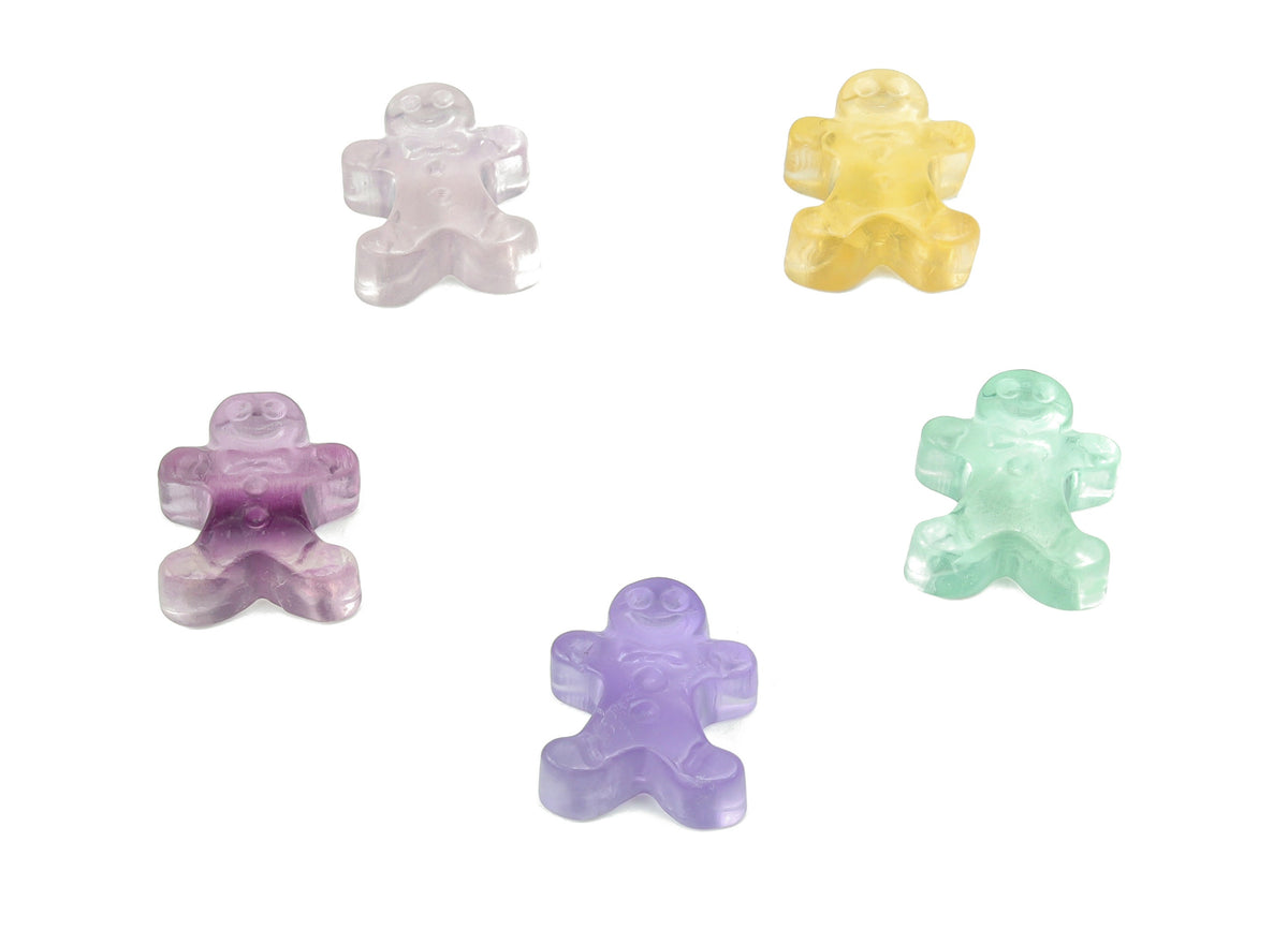Fluorite gingerbread cookies carving gemstone by GemstoneGO, showing a colorful, polished mineral with intricate gingerbread cookie design.