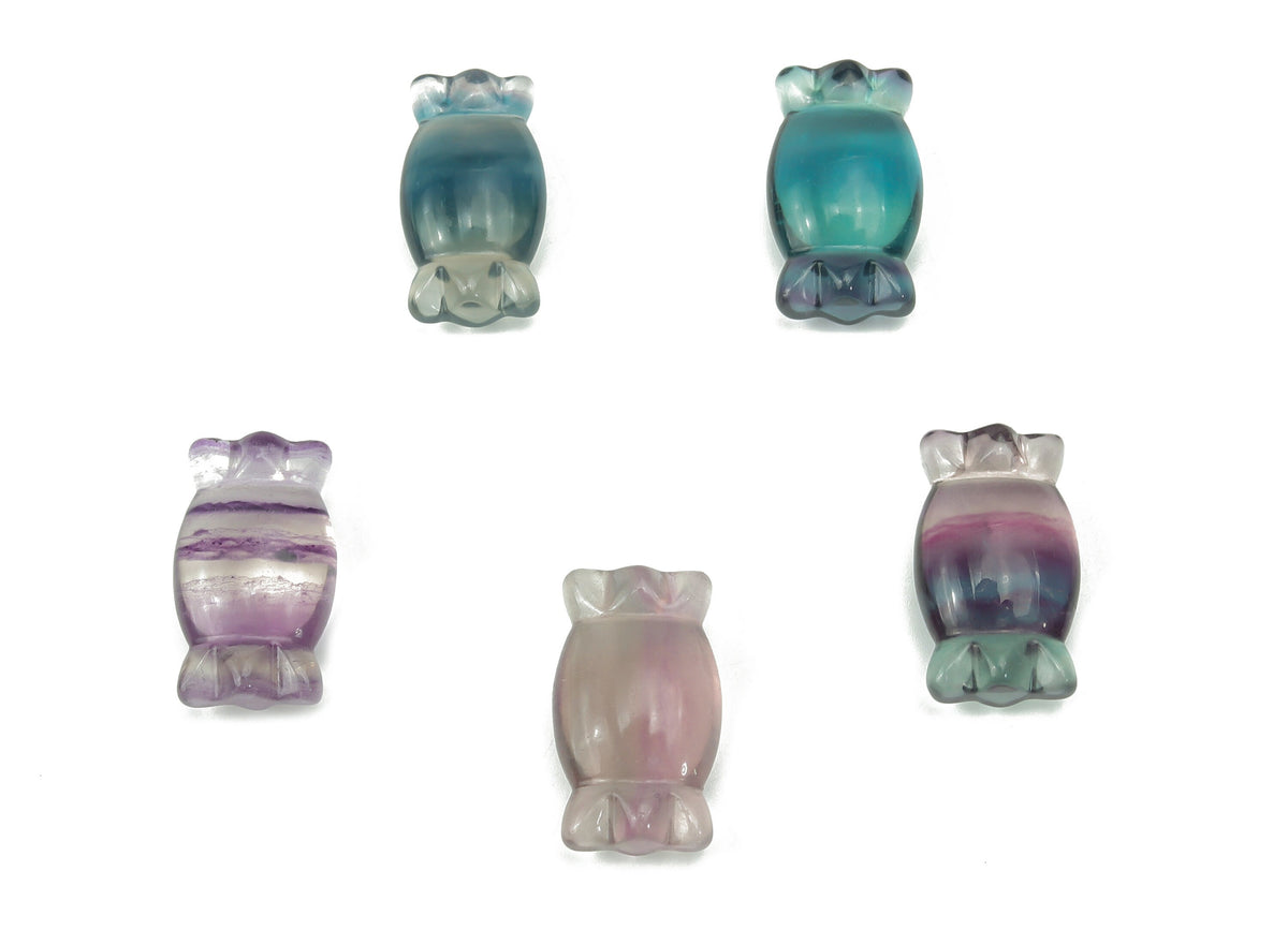 Fluorite candy carving gemstone from GemstoneGO with vibrant purple and green hues, showcasing intricate carving details.