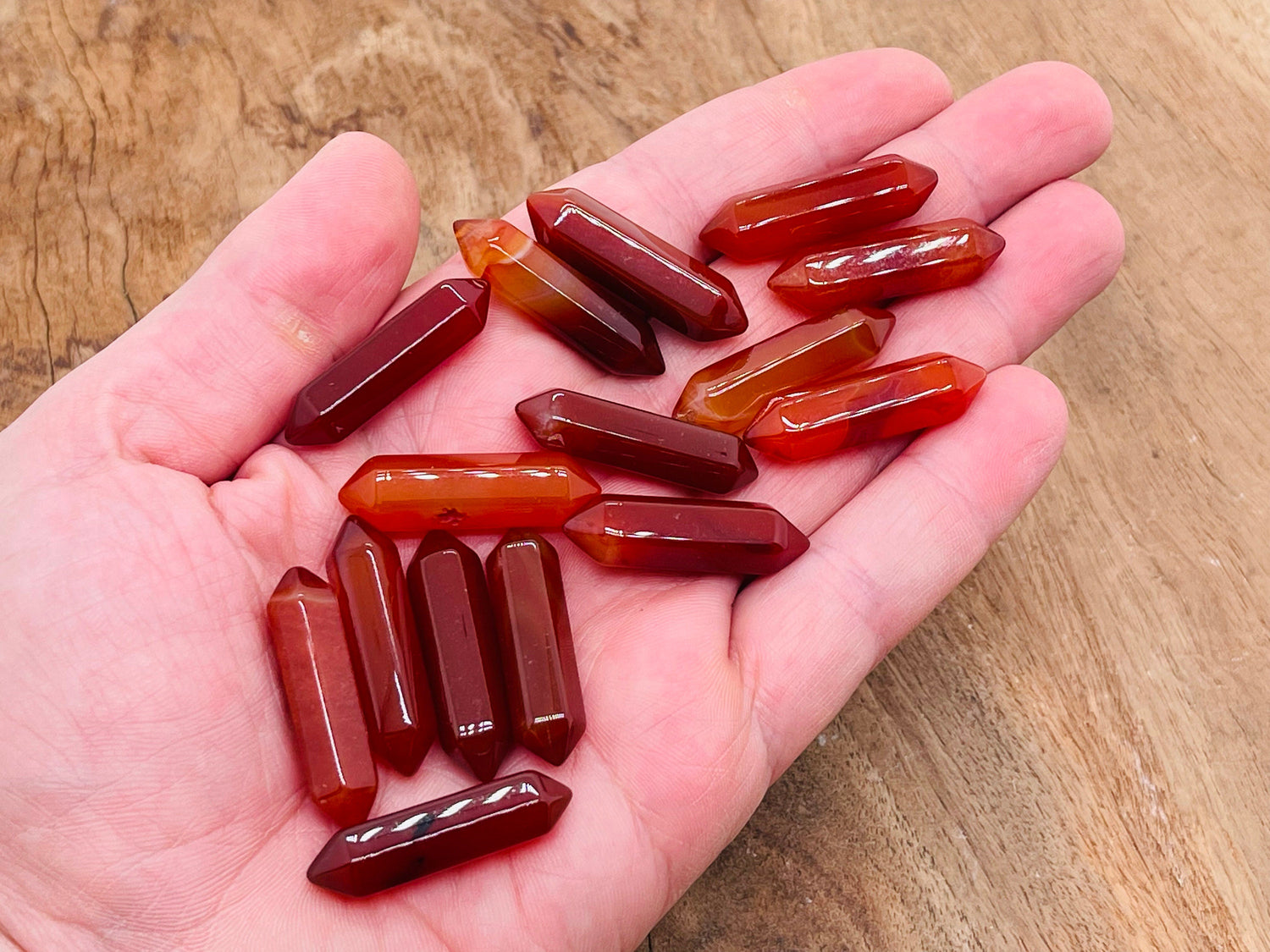 Carnelian terminated carved point gemstone from GemstoneGO, 33mm, featuring rich orange-red color and smooth polished surface.