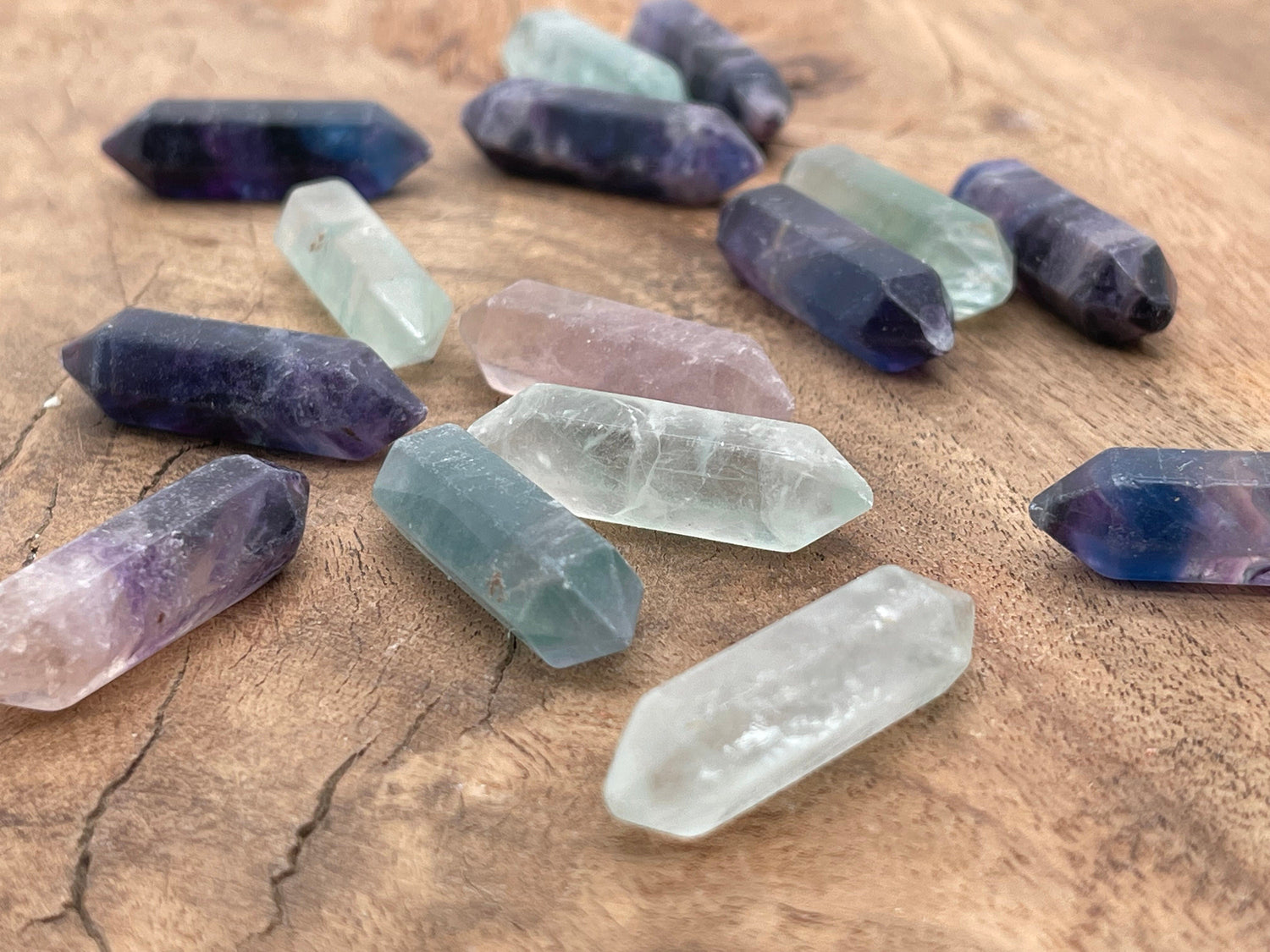 33mm fluorite terminated carved point gemstone from GemstoneGO, showcasing vibrant green and purple mineral layers.