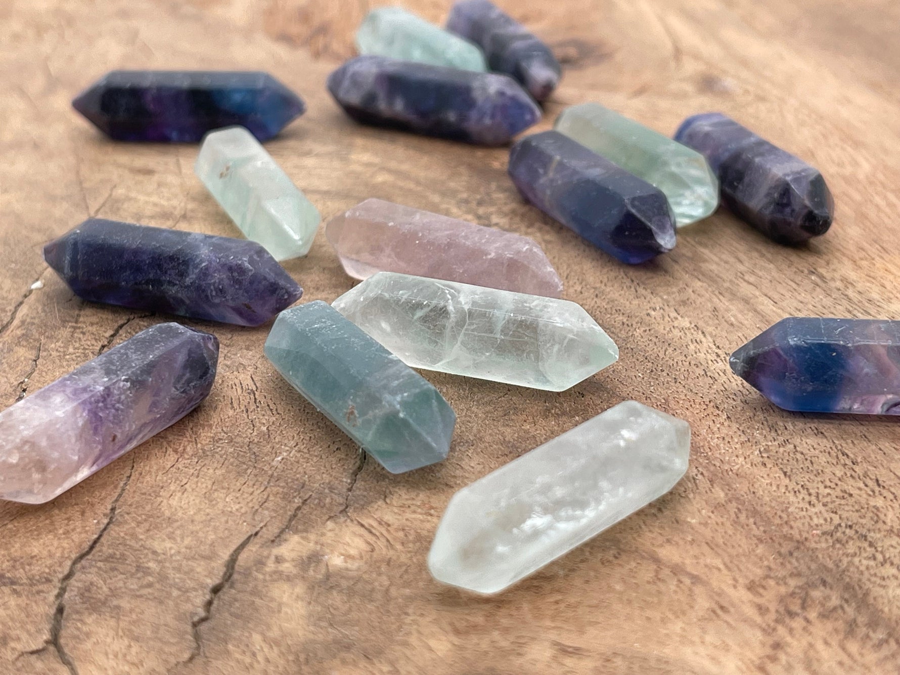 33mm fluorite terminated carved point gemstone from GemstoneGO, showcasing vibrant green and purple mineral layers.