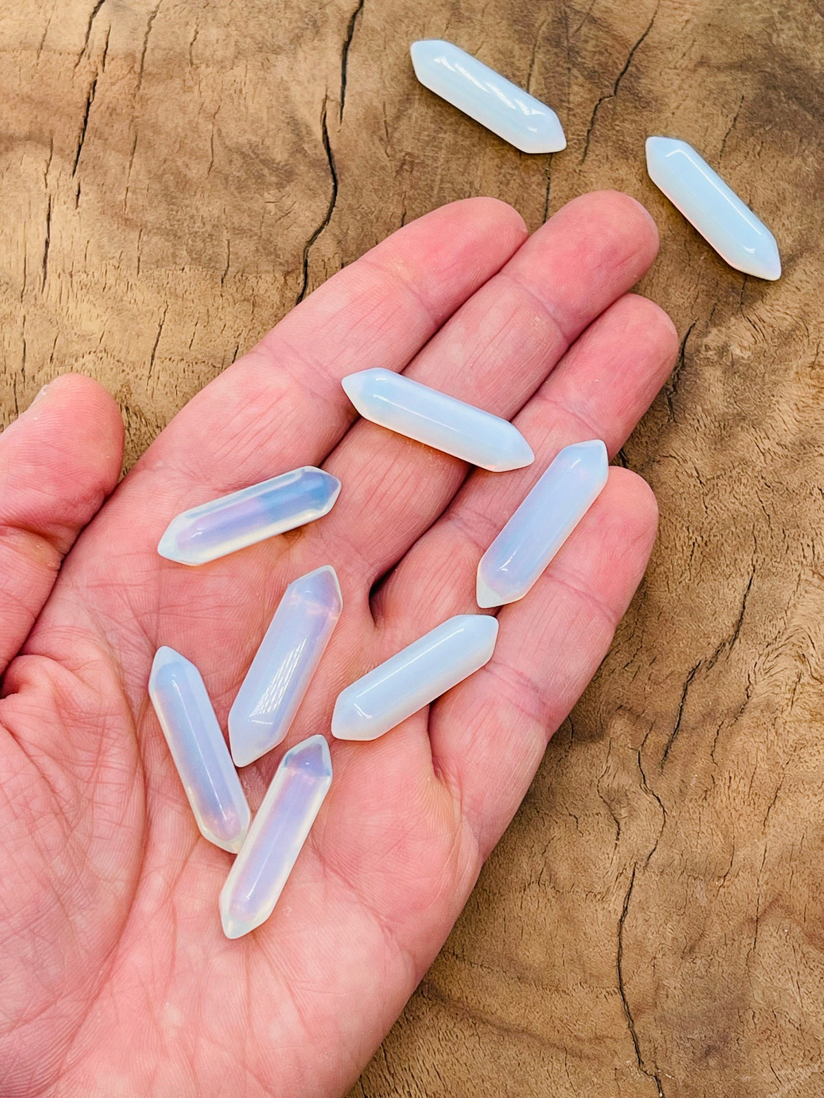 Opalite terminated carved point gemstone, 33mm, from GemstoneGO featuring a smooth, polished surface and natural stone patterns.