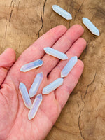 Opalite terminated carved point gemstone, 33mm, from GemstoneGO featuring a smooth, polished surface and natural stone patterns.
