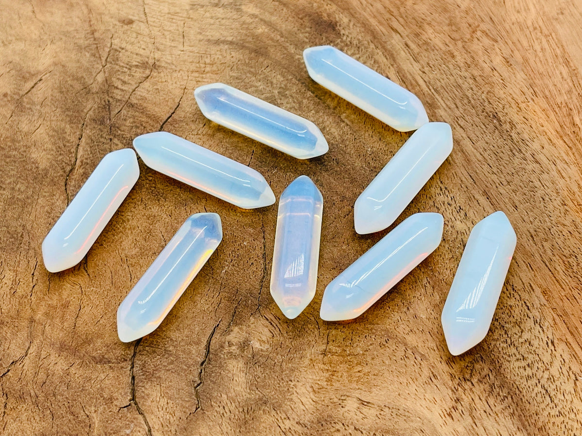 Opalite terminated carved point gemstone from GemstoneGO, 33mm, showcasing smooth, polished surface and natural opalite translucence.