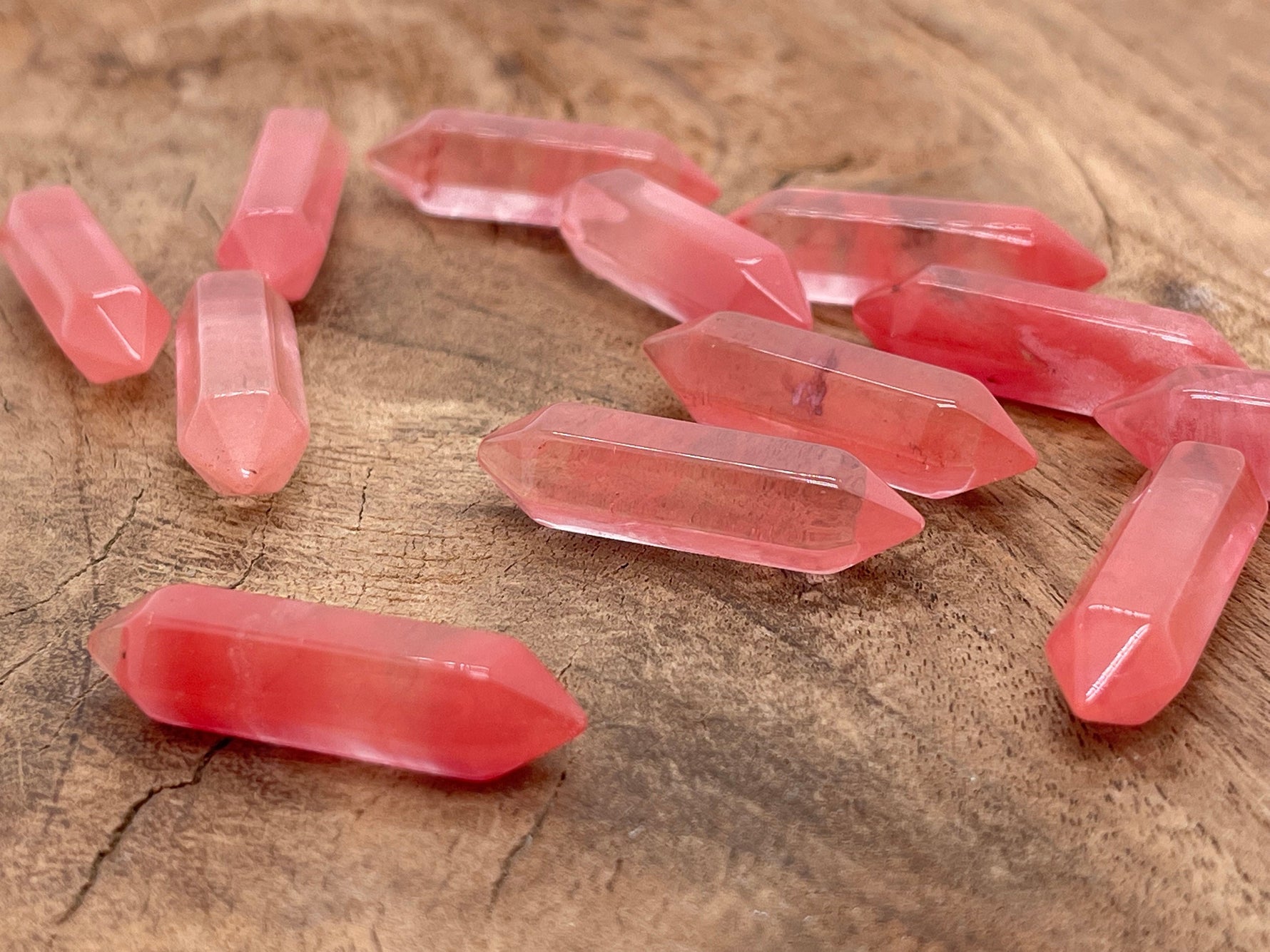 Cherry Quartz terminated carved point gemstone, 33mm, from GemstoneGO featuring a polished, pointed crystal with intricate carvings.