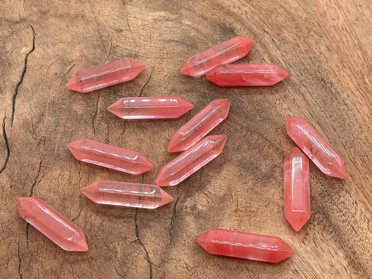 Cherry quartz terminated carved point, 33mm gemstone from GemstoneGO, showcasing a polished, pointed gemstone with intricate carvings.