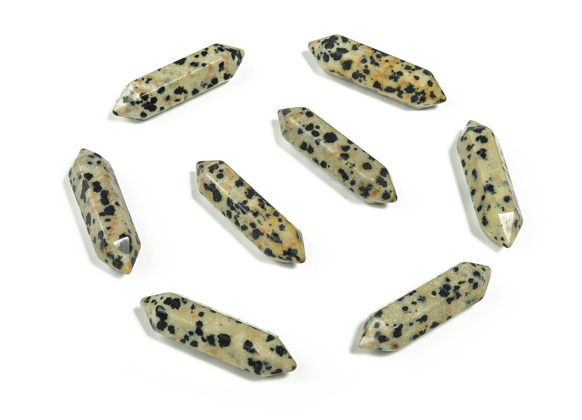 Dalmatian Jasper terminated carved point gemstone from GemstoneGO, 33mm, showcasing black spots on a cream-colored stone.