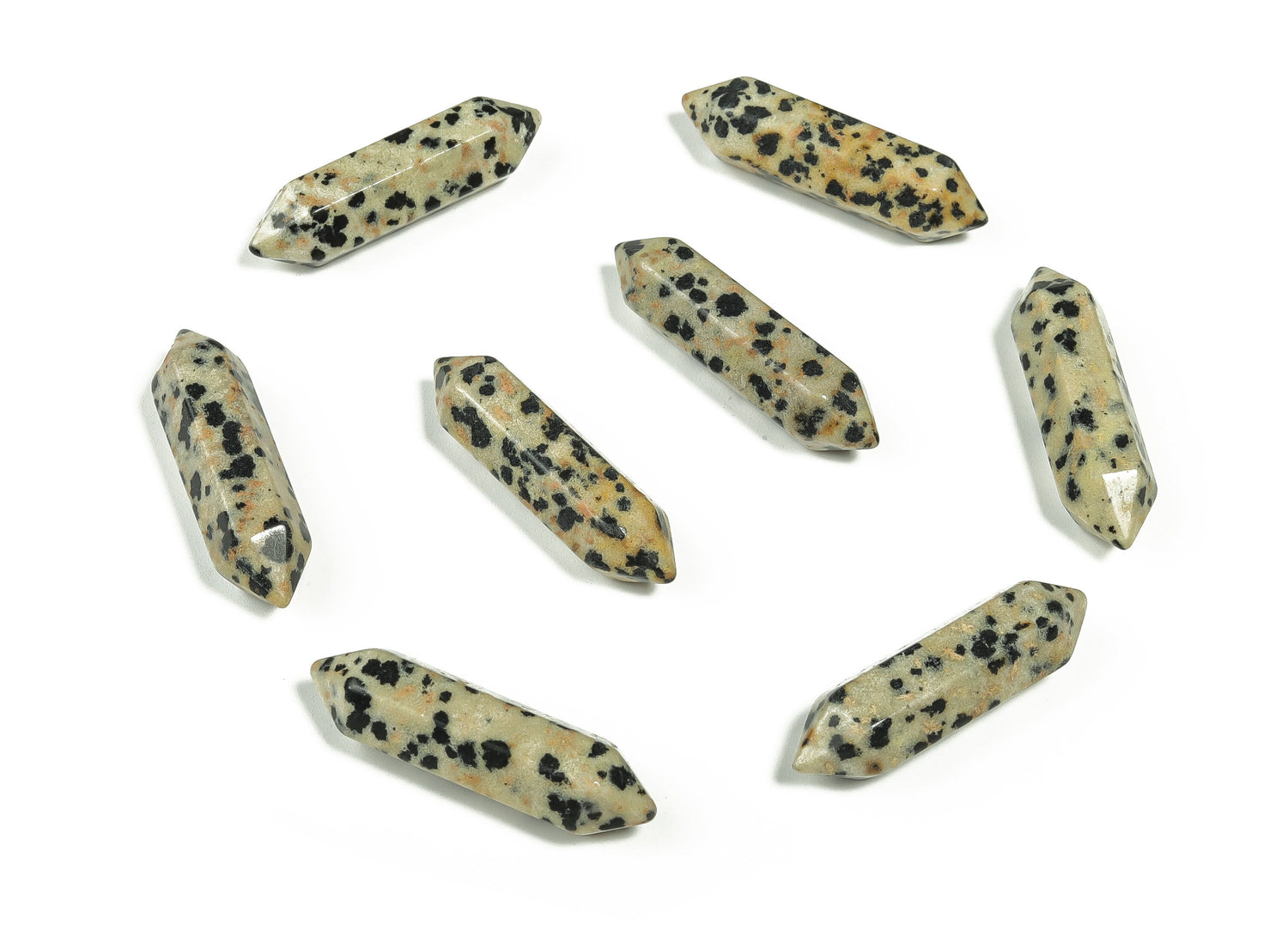 Dalmatian Jasper terminated carved point gemstone from GemstoneGO, 33mm, showcasing black spots on a cream-colored stone.
