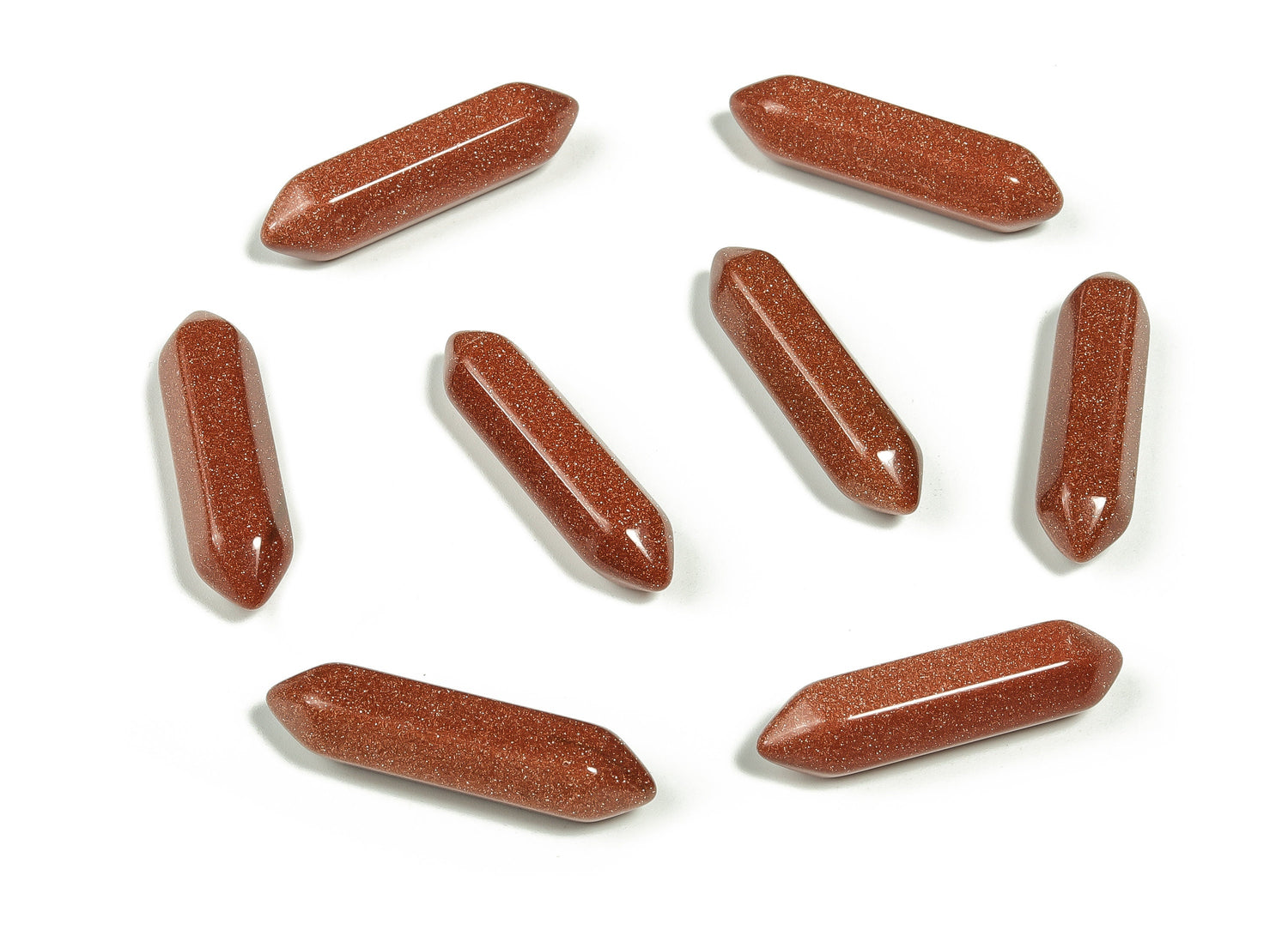 Golden Goldstone terminated carved point gemstone, 33mm, from GemstoneGO, featuring intricate carving and a shiny, reflective surface.
