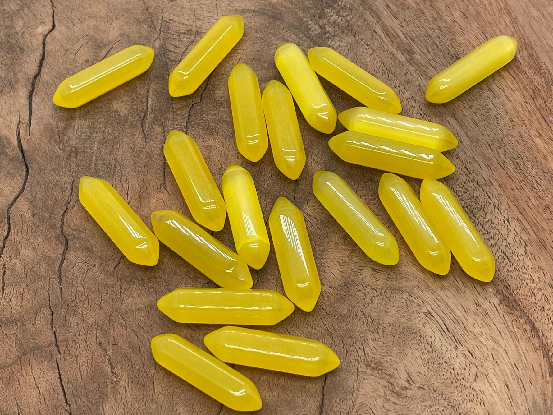 Yellow Cats Eye gemstone carved point, 33mm, from GemstoneGO, featuring a polished, carved termination with vibrant yellow color.