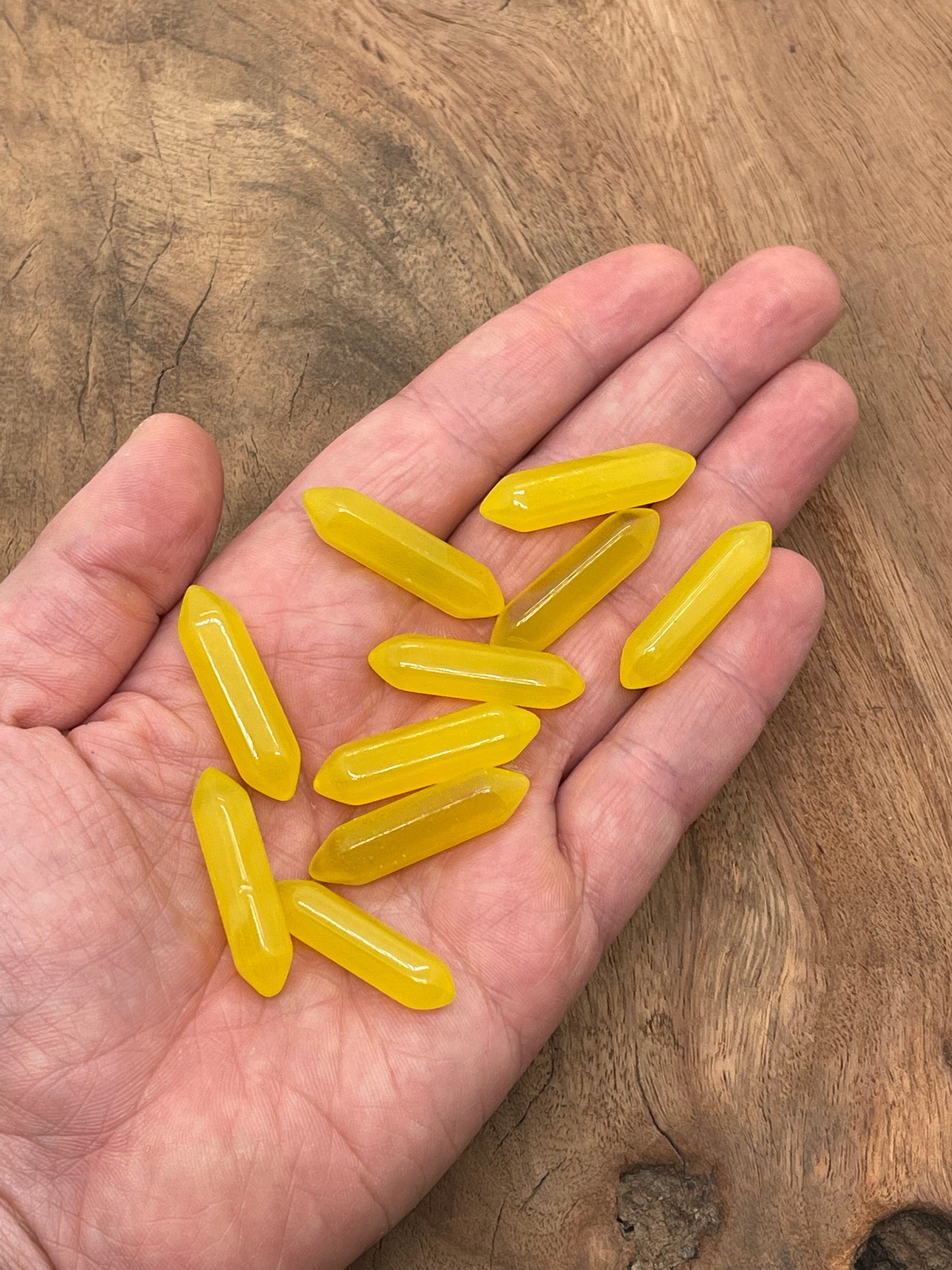 Yellow Cats Eye gemstone carved point, 33mm, with a polished terminated shape from GemstoneGO, showcasing vibrant color and detailed carving.