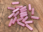 Pink Cats Eye gemstone carved point, 33mm, from GemstoneGO, showing polished carved stone with a pink cat's eye effect.