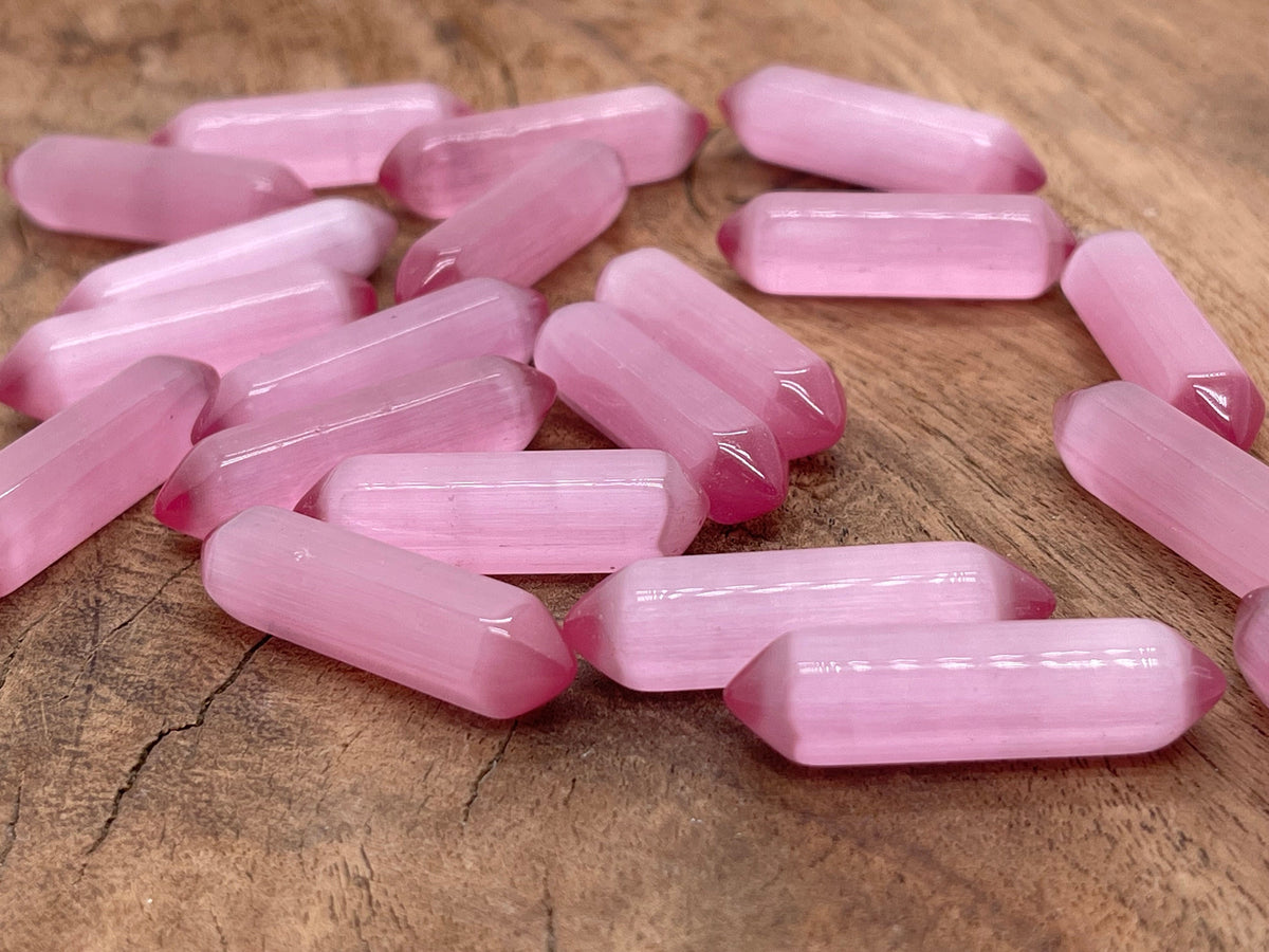 Pink Cats Eye gemstone carved point, 33mm, from GemstoneGO showcasing a polished, carved cabochon with vibrant pink and chatoyancy.
