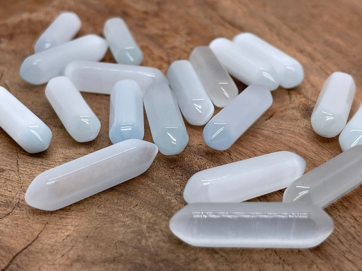 White cats eye gemstone carved point, 33mm, from GemstoneGO featuring a polished, carved cat's eye effect in a white tone.