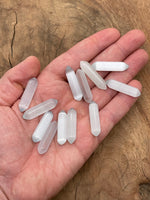White Cats Eye gemstone carved point, 33mm, from GemstoneGO, showing smooth polished surface and intricate carved details.
