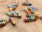 Murano glass terminated carved point gemstone from GemstoneGO, 3cm in length, with intricate carved details and vibrant colors.