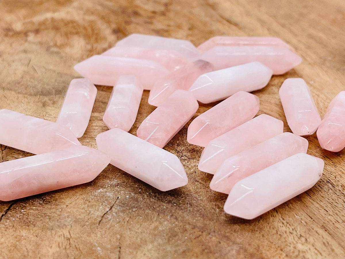 Rose quartz terminated carved point gemstone, 33mm, from GemstoneGO, showcasing a smooth, polished pink quartz crystal point.