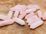 Rose quartz terminated carved point gemstone, 33mm, from GemstoneGO, showcasing a smooth, polished pink quartz crystal point.