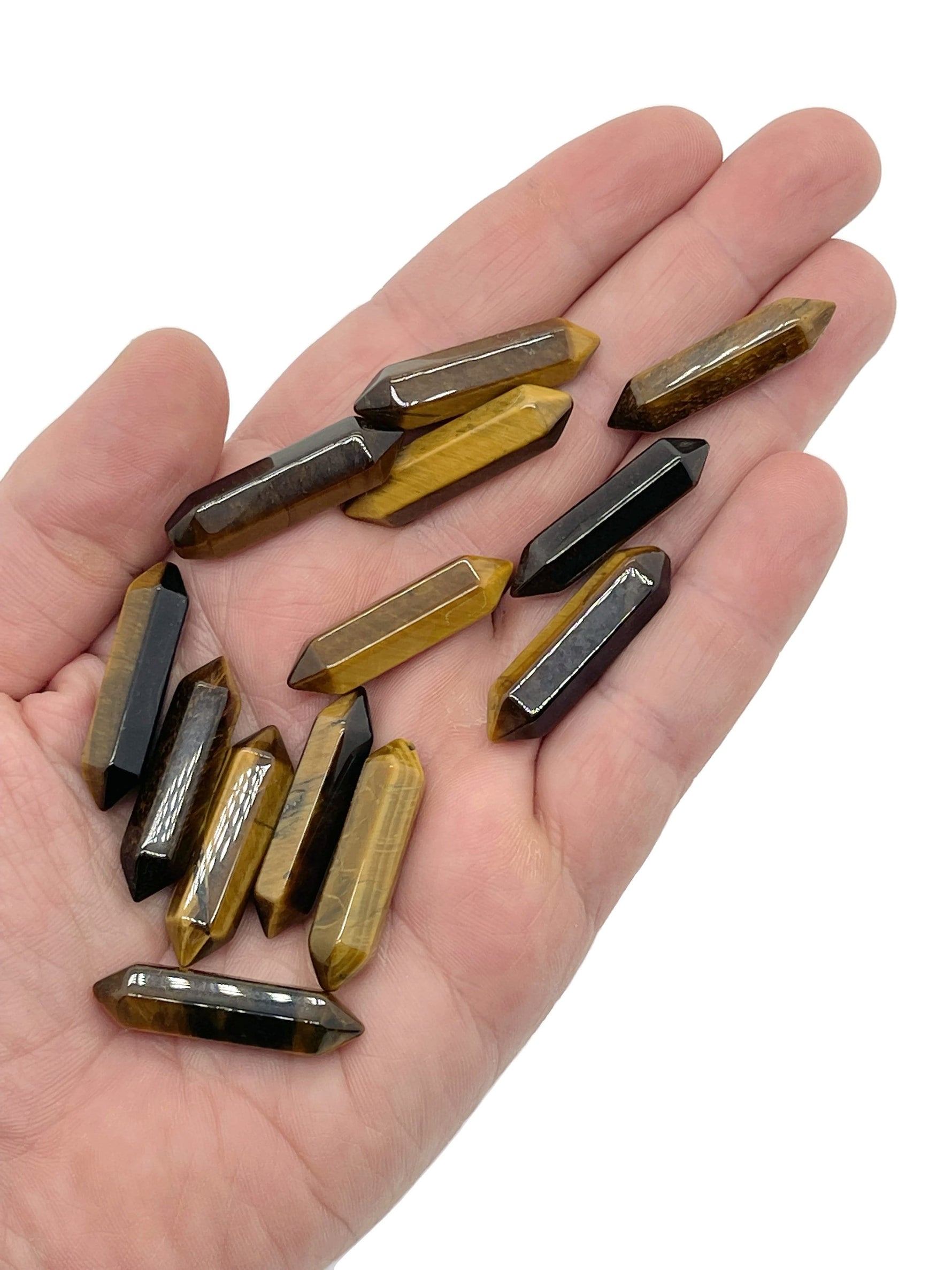 Tiger Eye terminated carved point crystal from GemstoneGO, 33mm, showcasing smooth polished surface and natural golden-brown color.