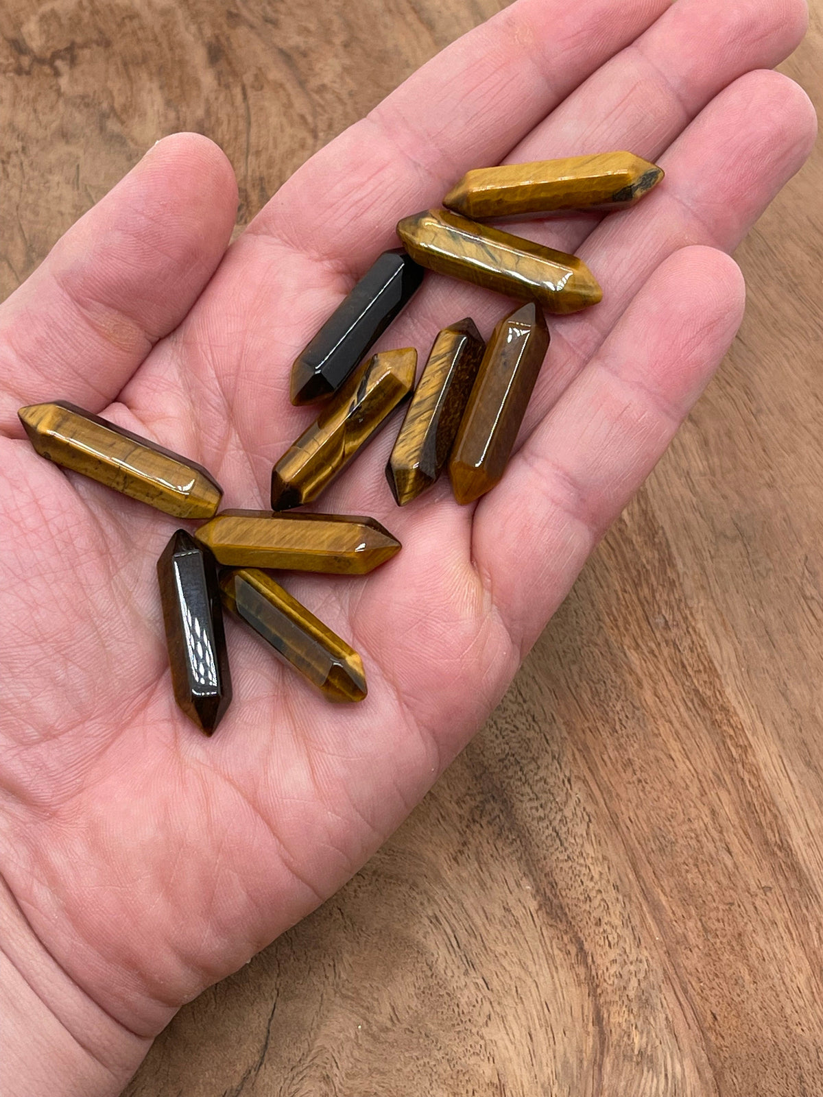 Tiger Eye terminated carved point gemstone, 33mm, from GemstoneGO, showing polished, pointed crystal with rich golden-brown color.