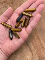 Tiger Eye terminated carved point gemstone, 33mm, from GemstoneGO, showing polished, pointed crystal with rich golden-brown color.