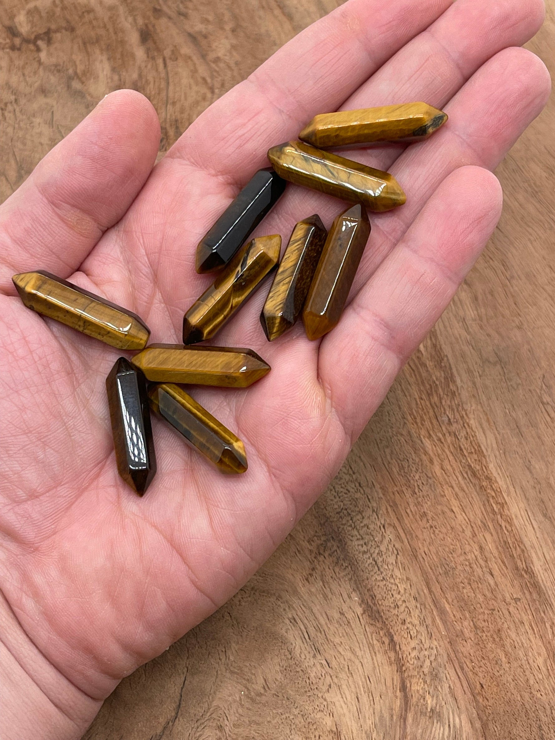Tiger Eye terminated carved point gemstone, 33mm, from GemstoneGO, showing polished, pointed crystal with rich golden-brown color.