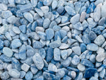Blue aventurine crystal chips in 5-7mm semi-tumbled stones, shown in bulk with vibrant blue color and smooth, irregular shapes.