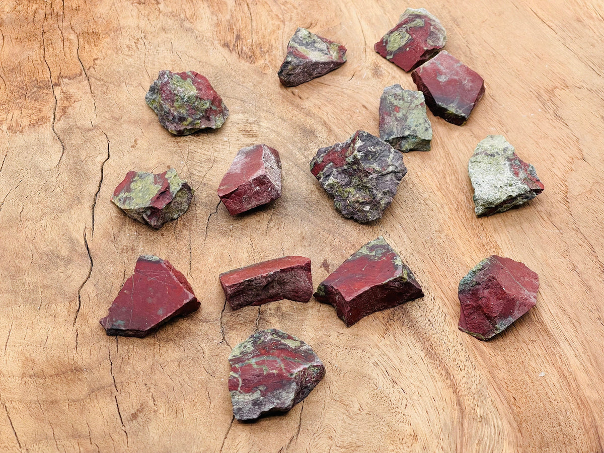 Raw Dragon Blood Jasper gemstone from GemstoneGO showing deep red and brown mineral patterns in a natural stone form.