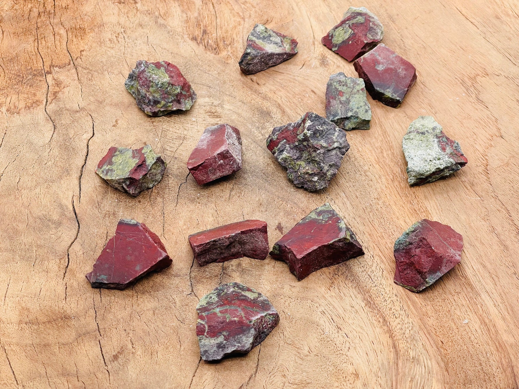 Raw Dragon Blood Jasper gemstone from GemstoneGO showing deep red and brown mineral patterns in a natural stone form.