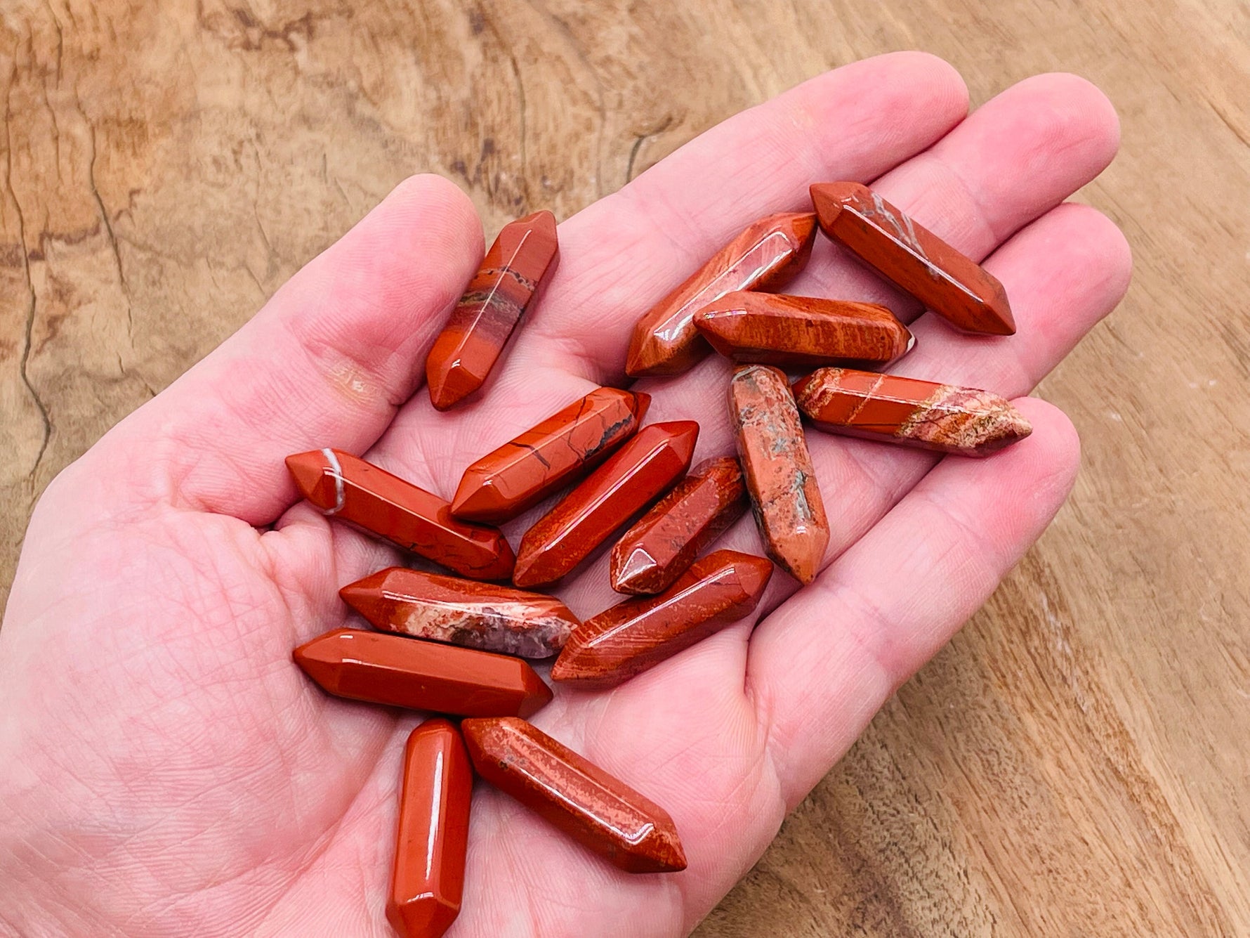 Red Jasper terminated carved point gemstone, 33mm, from GemstoneGO, showing detailed carving and vibrant red color.