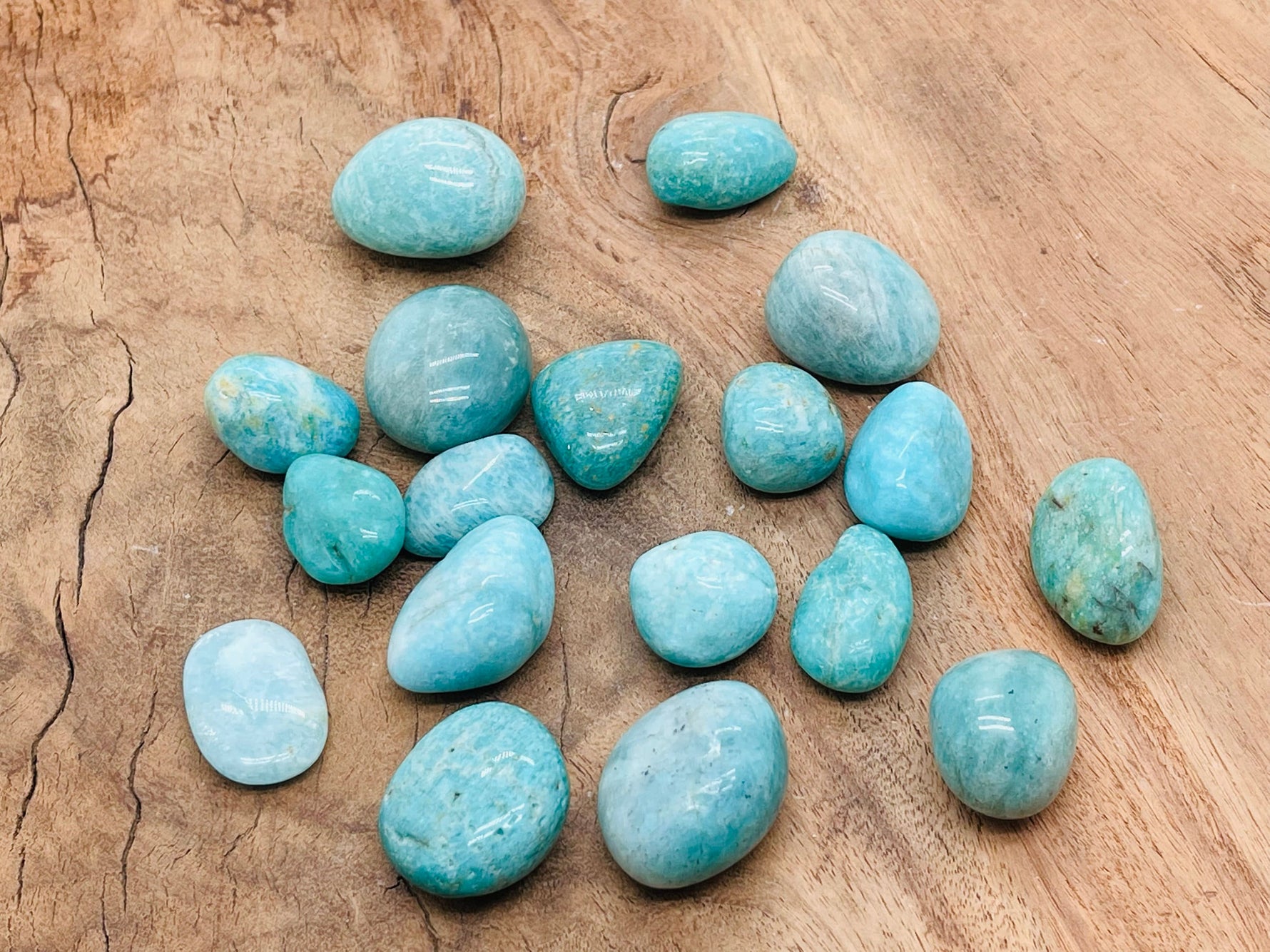 Polished Amazonite tumbled stone from GemstoneGO, showcasing its smooth, blue-green surface and natural mineral patterns.