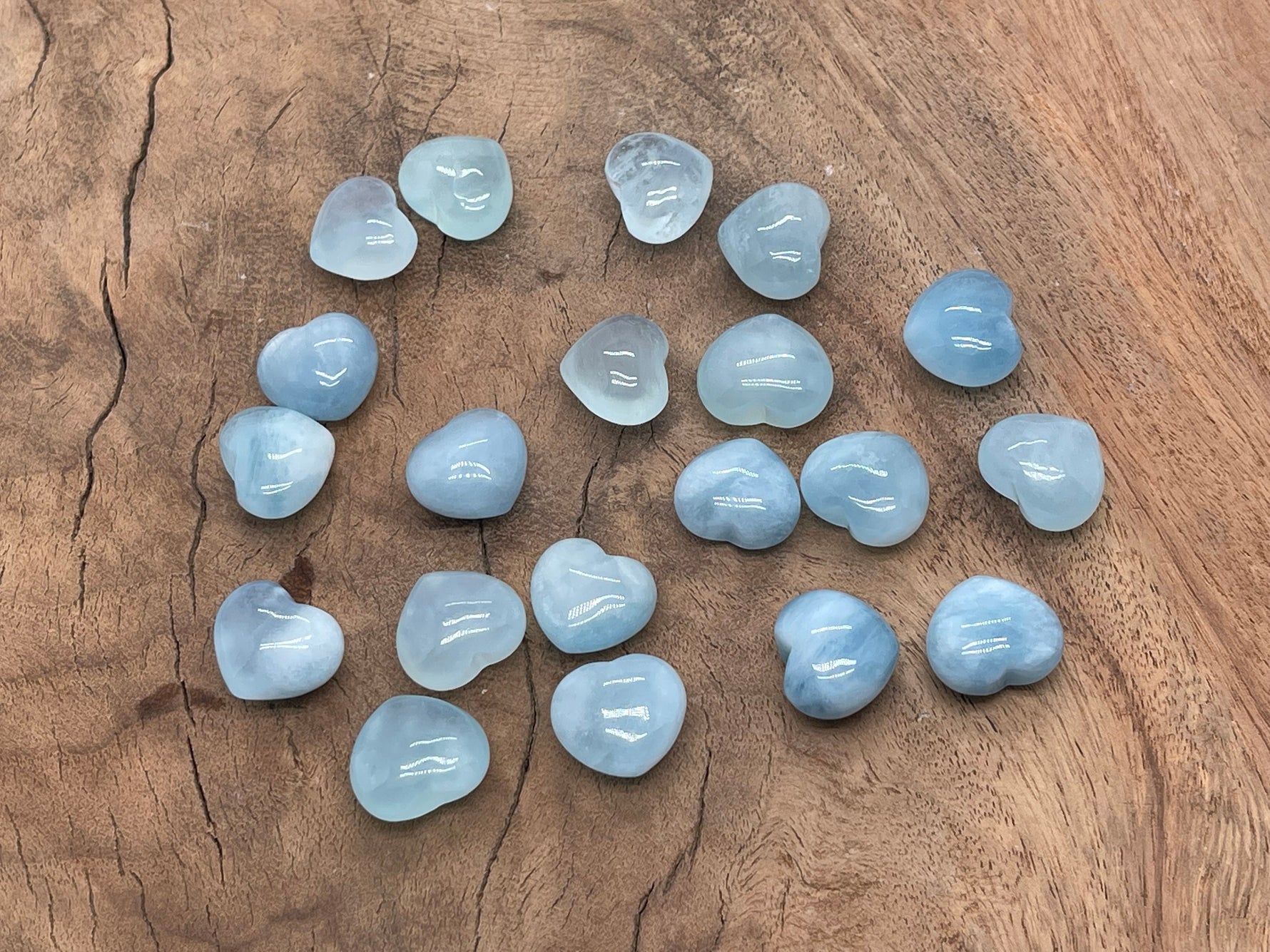 Aquamarine heart-shaped gemstone, 15x15x9mm, from GemstoneGO, showcasing its vibrant blue color and polished surface.