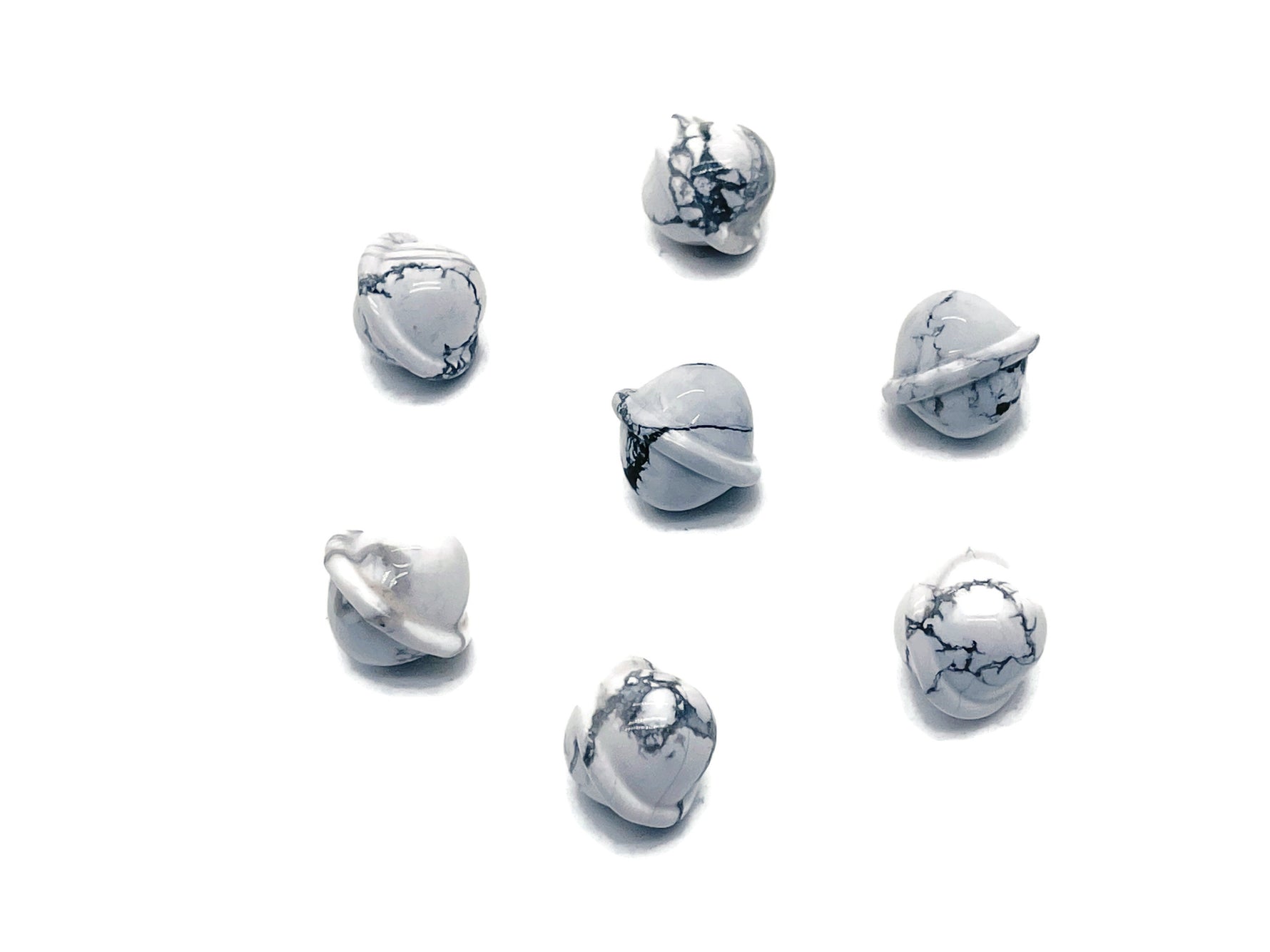 Mini Howlite Saturn crystal carved as a planet gemstone, 18mm, showcasing detailed planetary features and smooth surface.