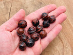 Mini mahogany obsidian Saturn crystal carved as a gemstone planet, 18mm gemstone with detailed planetary features.