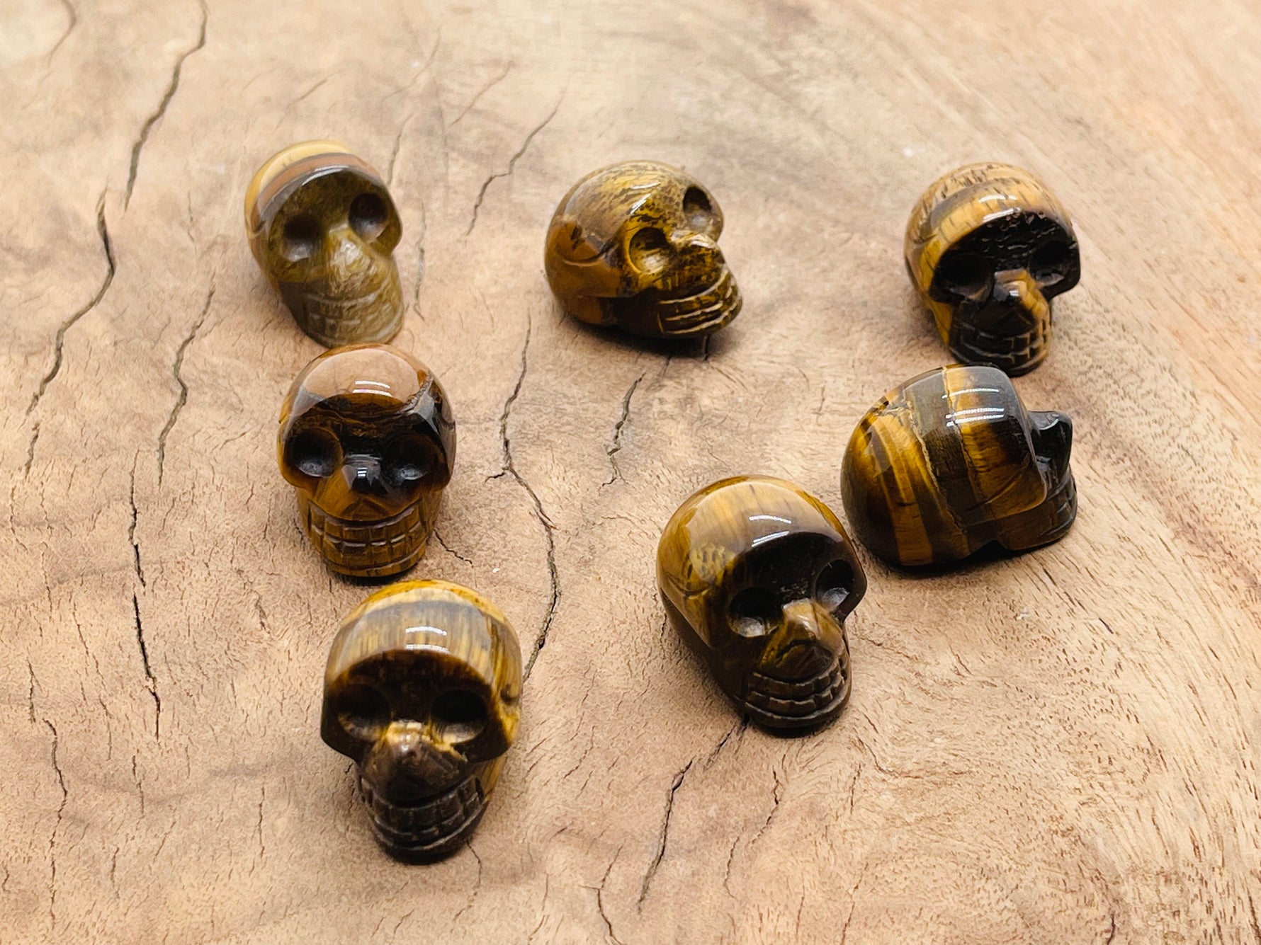 Carved Tiger Eye skull gemstone, 25mm, with detailed features and rich golden-brown color, by GemstoneGO.