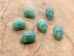 A 25mm carved aventurine skull gemstone from GemstoneGO, showing detailed green stone carving with natural texture and polished finish.