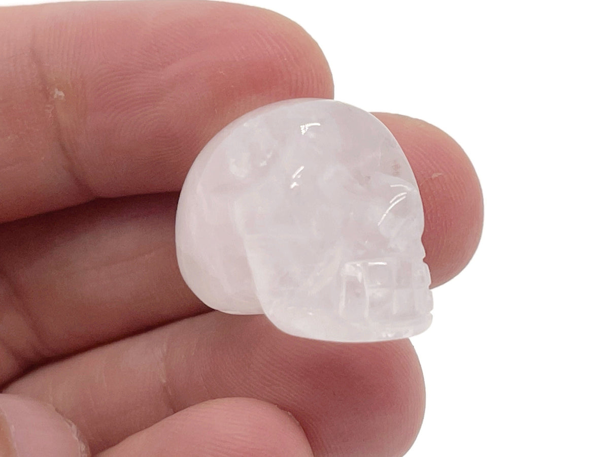 Clear quartz skull carved gemstone, 25mm, by GemstoneGO, showing detailed craftsmanship and polished surface.