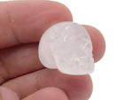 Clear quartz skull carved gemstone, 25mm, by GemstoneGO, showing detailed craftsmanship and polished surface.