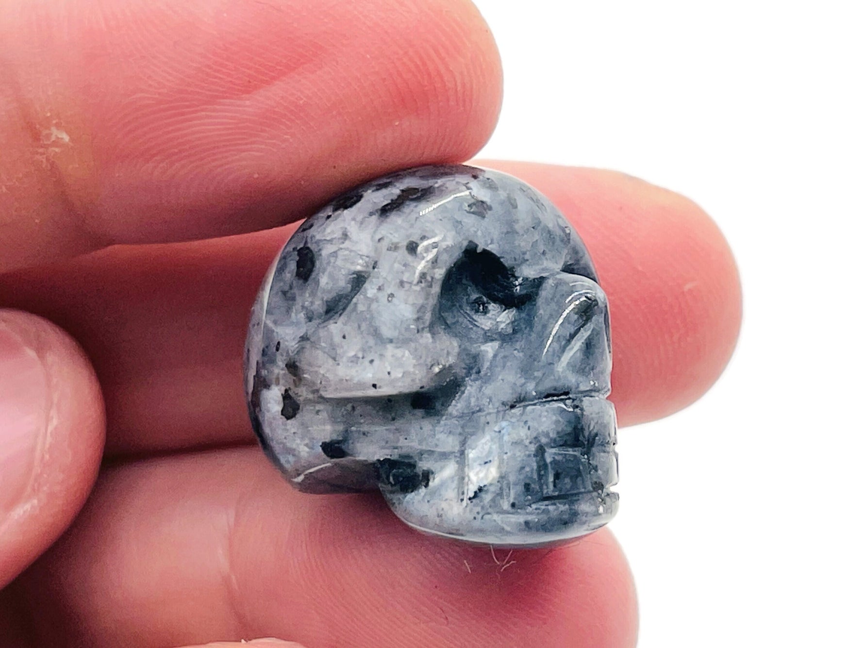 Larvikite skull carved gemstone, 25mm, detailed natural stone sculpture from GemstoneGO, showcasing polished dark blue and gray hues