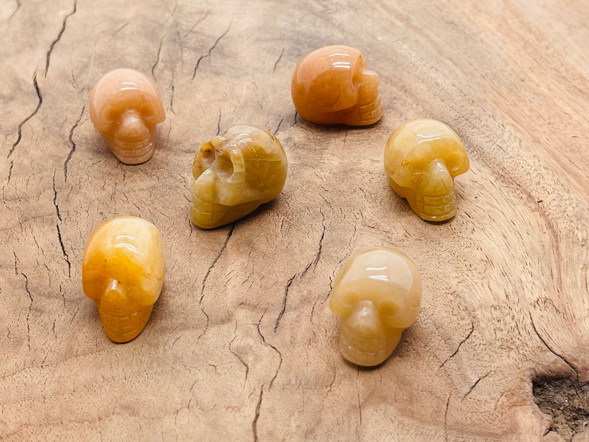 Orange aventurine skull carved gemstone, 25mm, featuring detailed carving and vibrant orange color, from GemstoneGO.