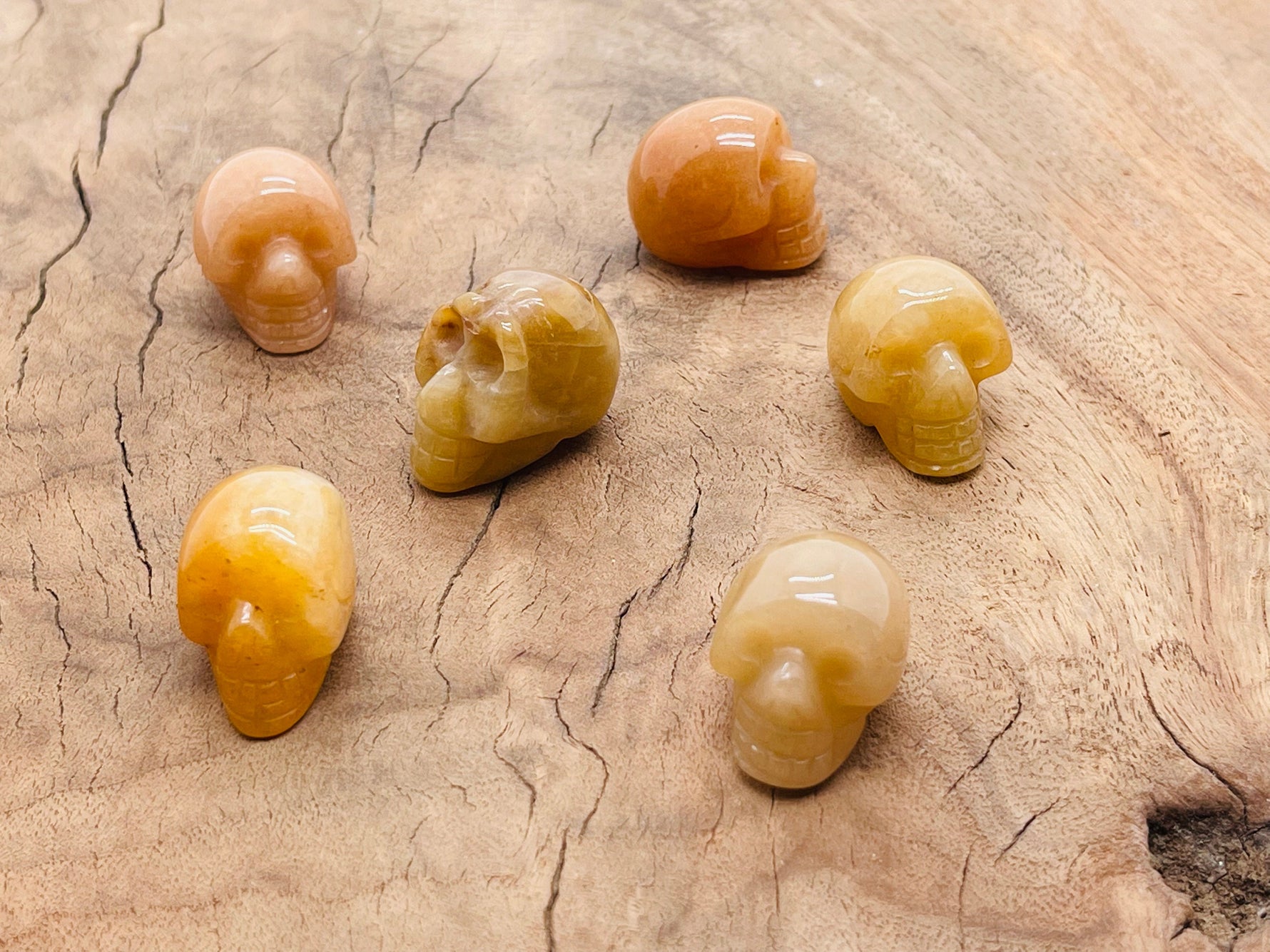 Orange aventurine skull carved gemstone, 25mm, featuring detailed carving and vibrant orange color, from GemstoneGO.