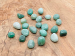 Polished aventurine tumbled gemstone from GemstoneGO, showcasing smooth green stone with natural patterns and glossy finish.