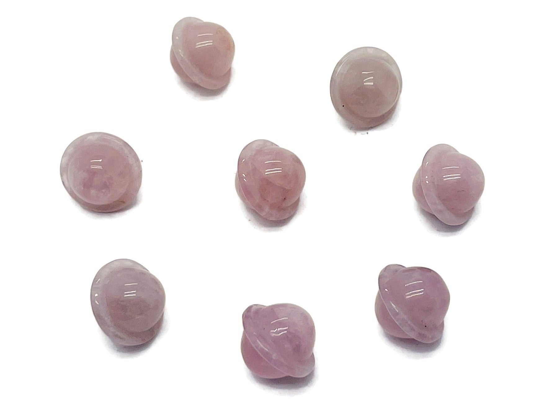 Mini rose quartz Saturn crystal gemstone carved as a small 18mm planet, showcasing a smooth, polished surface with natural pink hues.