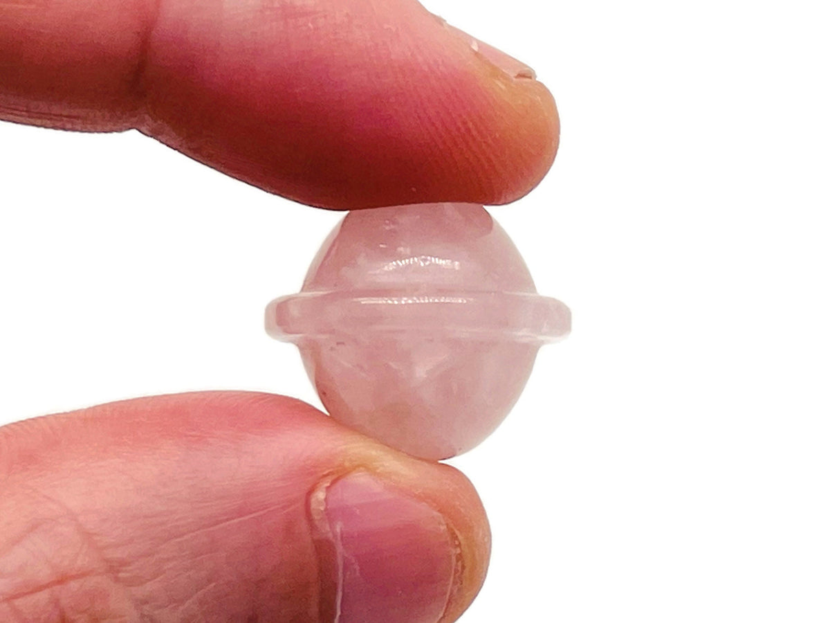 Mini rose quartz Saturn crystal carved as a planetary gemstone, 18mm, showcasing smooth pink stone and detailed ringed planet design.